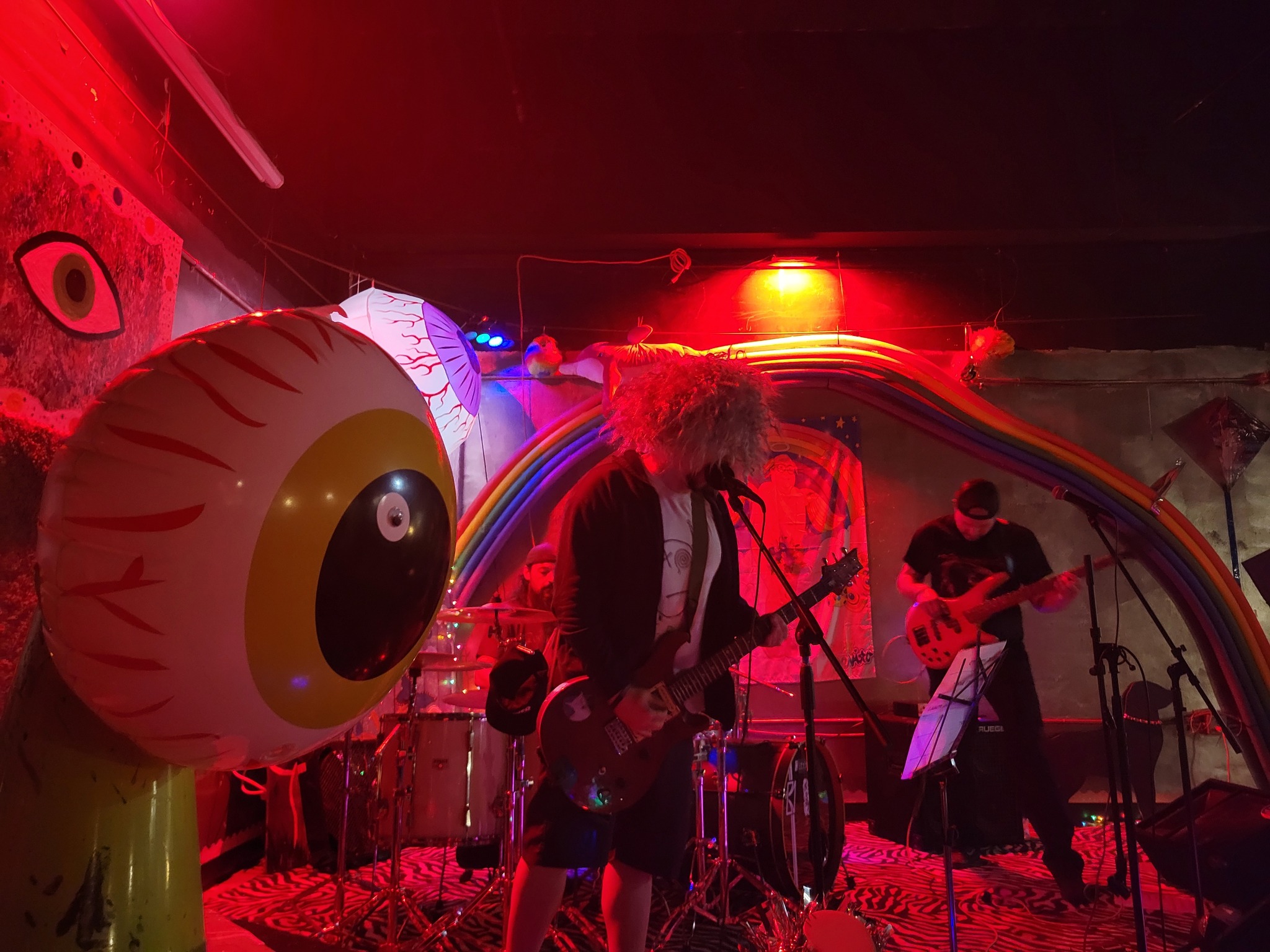 Live band under the rainbow and eyeball art