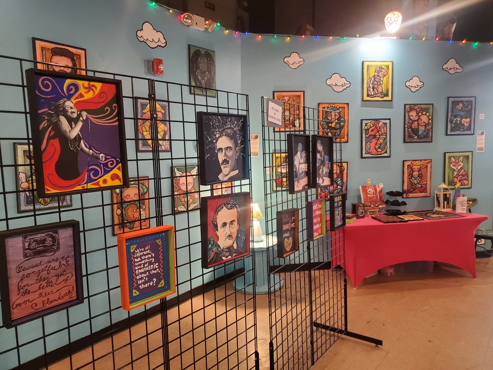 Wall of framed local art hung salon-style